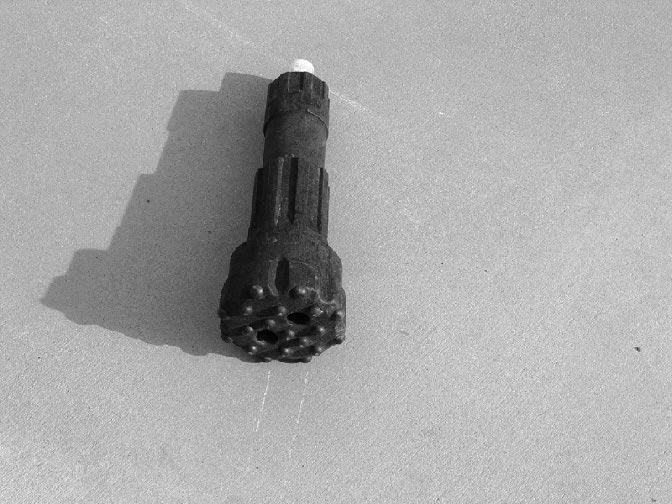 Figure 4-21. Down-Hole Bit for the percussion application. The carbide button bit is more durable than other bits made from hardened steel. However, the drill bit dulls and buttons flatten from wear.