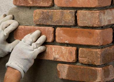 Press the corner piece onto the wall, rotating back and forth slightly, and forcing some of the mortar to squeeze out.