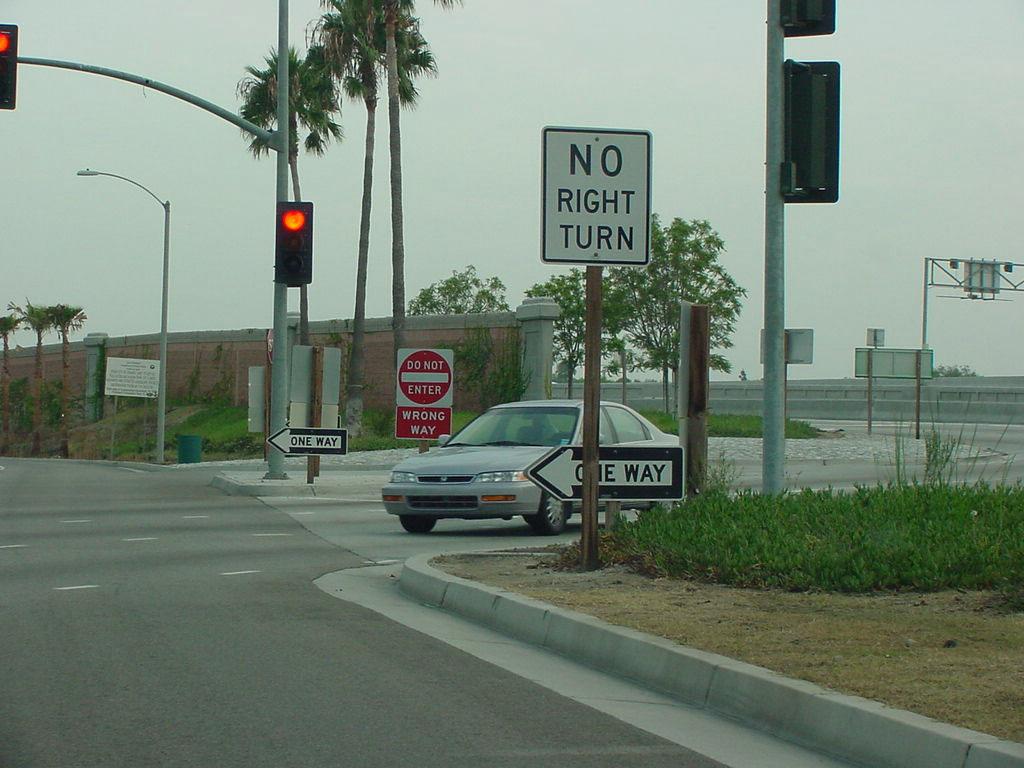 Lowered One Way and Turn Restriction Signs in California.