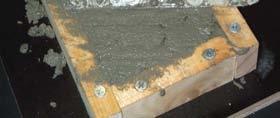 Remove excess concrete material from in and around the mould with the edge of the trowel.
