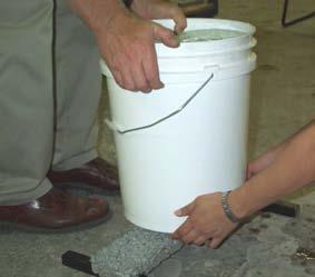 Place the H-shaped loading frame in the centre of the beam as shown below. 6. Slowly load the concrete sample by filling the bucket with 2 litres of water at a time.
