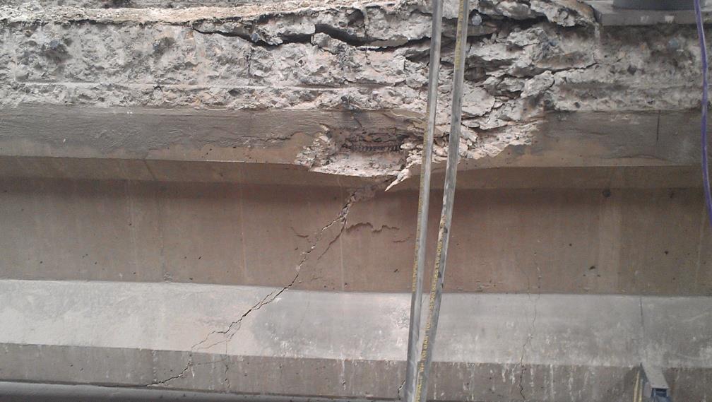 test, the girders also exhibited shear characteristics as shown in Figure 29. The shear cracks were approximately at an angle of 45 degree underneath the load.