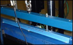 In cantilever batten tests, a 350 mm long batten specimen (cantilever length of 150 mm) was used to determine the pull-through load using a loading beam applying the loads at the two ends.