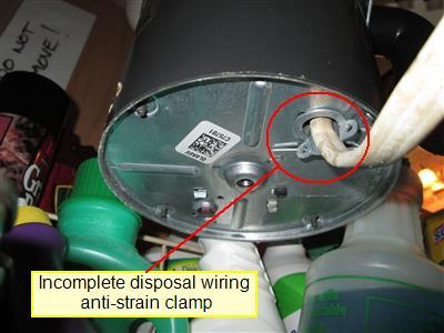 This clamp prevents the electrical wiring from being pulled loose from under the disposal. This is a potential safety issue until corrected. 10.