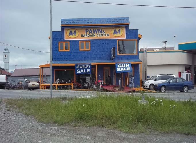 Photo 11: The pawn shop located along Main Street, adjacent north of the Tesoro filling station.