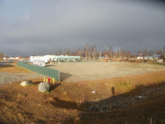 Photo 13: Unpaved storage lot located west of the would-be extension of the Talkeetna Street ROW.