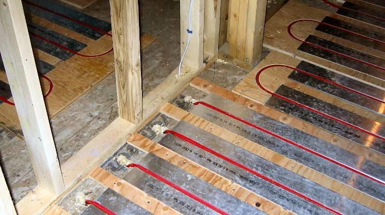 ROUTING PIPE TAILS TO MANIFOLDS DRILL 1 INCH HOLE AT 45-DEGREE ANGLE IN SUBFLOOR RUN PIPES THROUGH THE JOIST