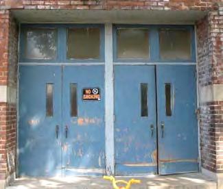 (Figures 6-7) The original entry doors of the 1905 building were glazed wood panel doors with transoms. (Figures 8-9) The appearance of the original entry doors of the c.