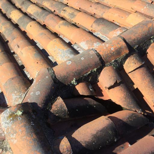 CURRENTLY LOOSE PIECES OF CLAY TILES ARE DISCONNECTED AND ARE LAYING AROUND SLOPED PORTIONS OF THE ROOFING SYSTEM PRESENTING WATERPROOFING ISSUES AND PRESENTING RISK