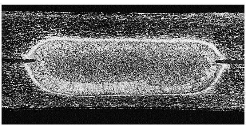 Microstructure of a Resistance Weld FIGURE 32-5 A spot-weld nugget between two sheets of 1.3-mm (0.05-in.) aluminum alloy.