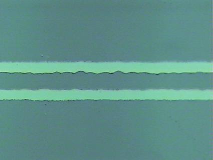 Since the peak energy intensity of the laser beam is higher than the crystallization threshold of a-ito and is lower than the ablation threshold, the center of the line is crystallized.