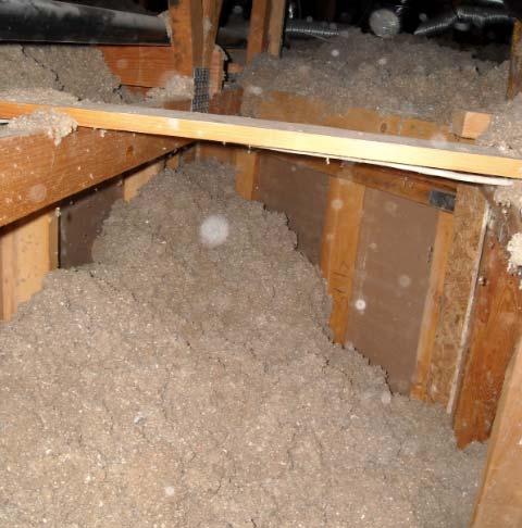 The second and third photos are from the attic looking down into this dropped soffit. You can see how the loose fill insulation has fallen down into the dropped area.