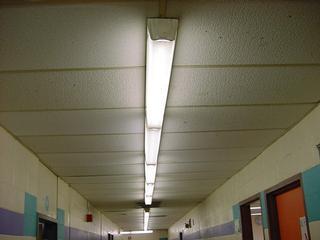 The 1986 addition contains 2x4 recessed mounted fluorescent fixtures retrofitted with T8 lamps and electronic ballast and single level lighting in fair condition and provides 70 FC in a typical