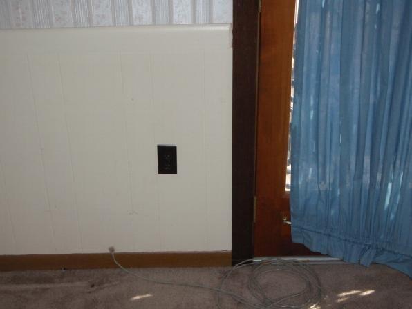 Walls: Paneling and painted drywall. Non-structural cracks and cosmetic blemishes are not included in this report. Floors: The kitchen floor is sloping downward toward the rear entry door.