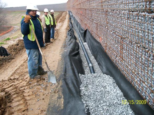 Bottom ash mined from the BAP was placed and compacted in the grid zone of the MSE wall.
