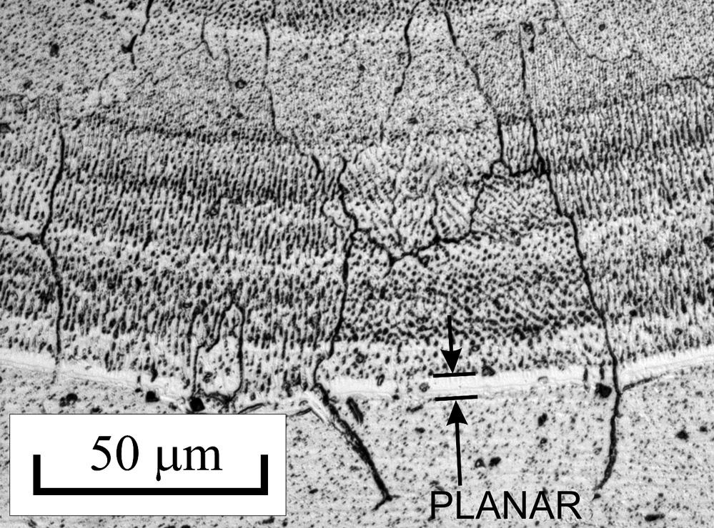 The solidification was initially planar over a narrow band at the fusion boundary adjacent to the base metal. This band was about 1.5 μm wide.