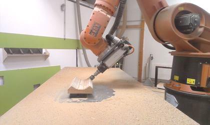 An articulated-arm robot known from large-scale production is used in the production process. This robot was adapted for woodworking and equipped with a special hold and control system.