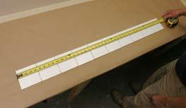 Using a level, find the lowest point on your wall and use this as the point to measure the height of your wall to be tiled then, using your level, draw a horizontal line through the midpoint for the