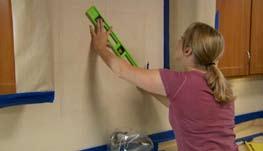 Glossy paints will bond better if they are lightly sanded with a course sandpaper to de-gloss. Wallpaper should be removed and the surface repainted if damaged.