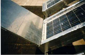 Diffuse reflectors between the parallel rows of the installed PV/T collectors on horizontal roof.