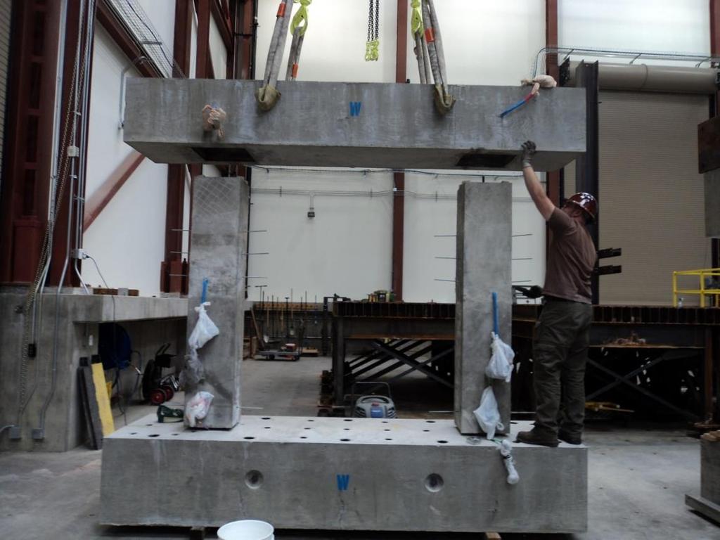 Figure 34. Inserting cap beam on top of the columns Pretest pushover and nonlinear dynamic analysis of the bent was conducted and the shake table testing protocol was developed accordingly.