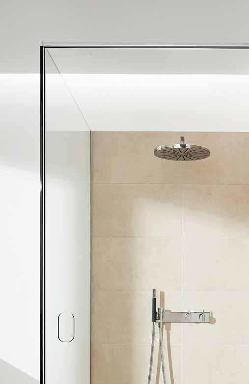 The beautiful glass shower door is mounted with exclusive and stylish fittings that emphasise the