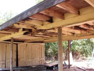 The beams supported 2 x 6, 20 long joists with 1 x 6 decking and a sheet metal rolled roof.
