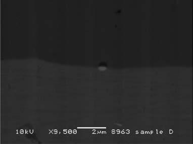 Figure 4 SEM images (BSE mode) of AA050 after anodizing for 0 min showing interface between the anodic oxide film/aluminium substrate of round-shape, irregular-shape Fe-containing particles, and