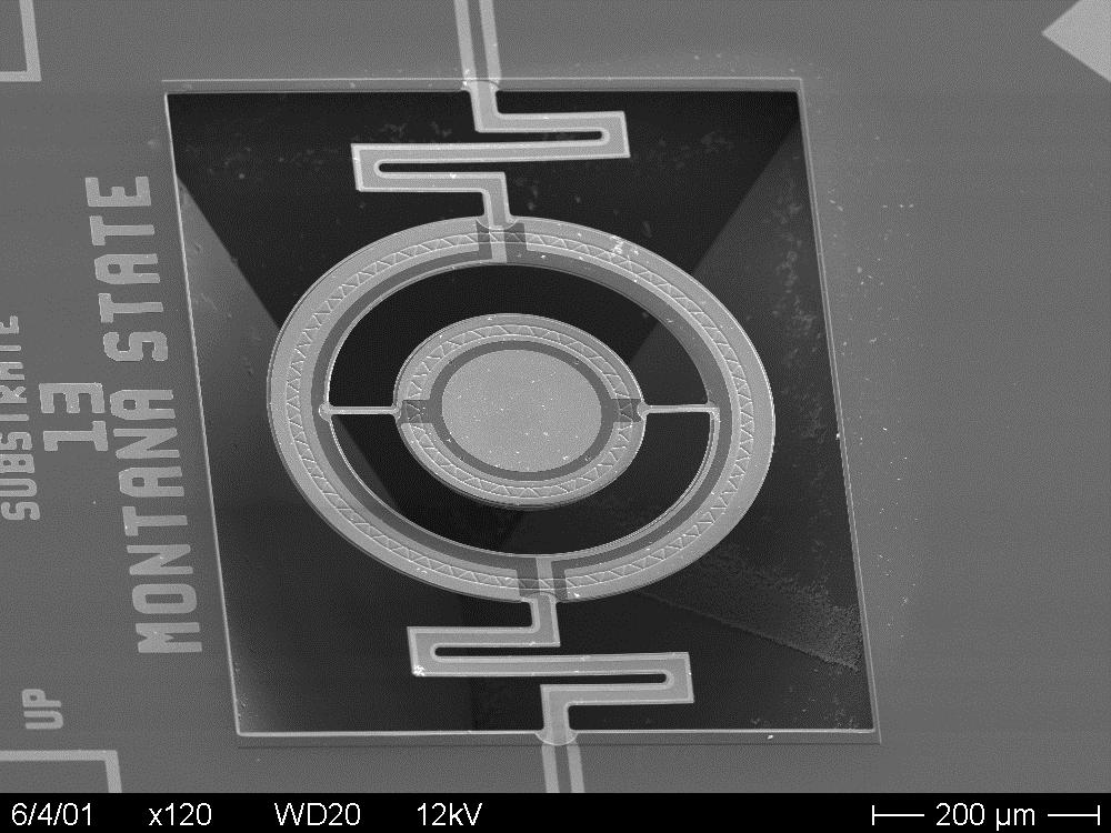 Various concentrations and etch temperatures were used. A 5% solution of TMAH at 80 ºC produced an etch rate of 25 µm/hr under the silicon nitride with the stiffening ribs.