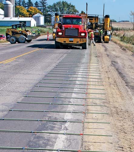 5 inch (114 mm) roadway, eight inch (203 mm) shoulder HW-101120 D12 The existing asphalt surface was milled, swept, and cleaned to prepare for the unbonded concrete whitetopping.