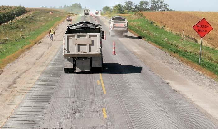 8 m) long, were placed on 30 inch (762 mm) centers on the existing roadway to tie on the new eight inch (203 mm) thick shoulder.