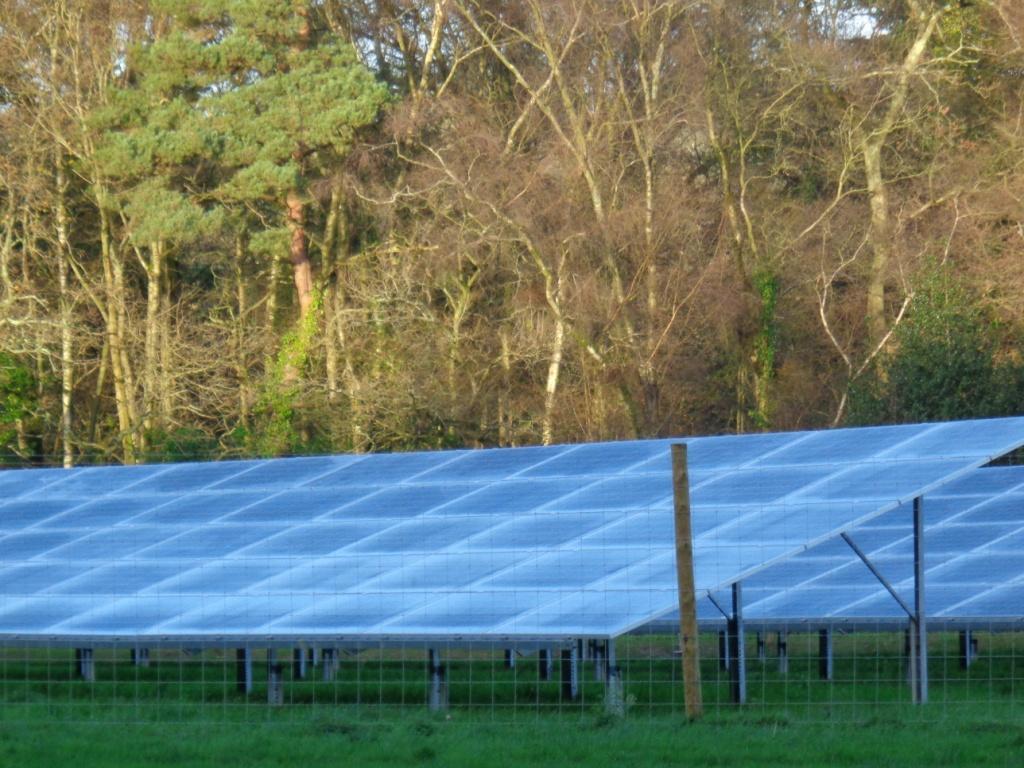 A UK solar farm installation in the winter covered in frost Millions of acres of land in the UK is being covered with solar PV panels
