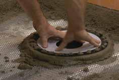 conjunction with the mortar bed. Place a ring of loose mortar up to the inlet hole in the floor and firmly press the drain into the mortar The screed is then placed flush with the top and level.