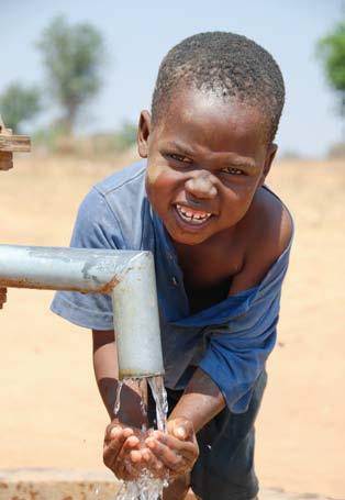 2008 World Vision WATER, Five-year-old Dauti washes his hands at a well constructed by World Vision in his village in Zambia.