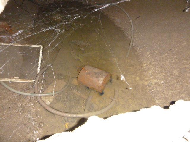 Crawlspace under the family room: 1. Repair/replace faulty sump pump (water ponding was noted). 2. Replace improper discharge pipe and pit, install backflow valve. 3.