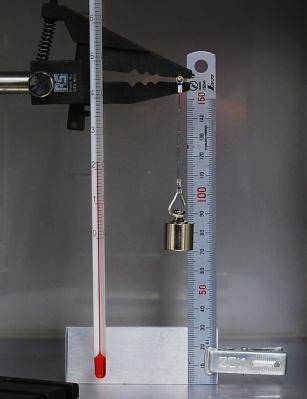 To evaluate the behaviour of the SMA-SMP composite structure it was suspended from one end with a weight attached to the other end and placed inside a lab oven which had a glass door, as shown in