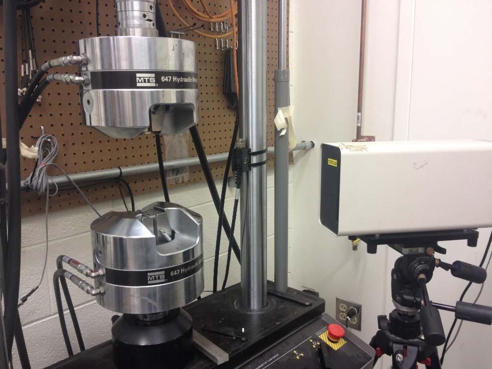 Carder 4 Figure 2: MTS Hydraulic Wedge Grip with SMA FRP specimen. Figure 3: MTS testing setup with laser extensometer.