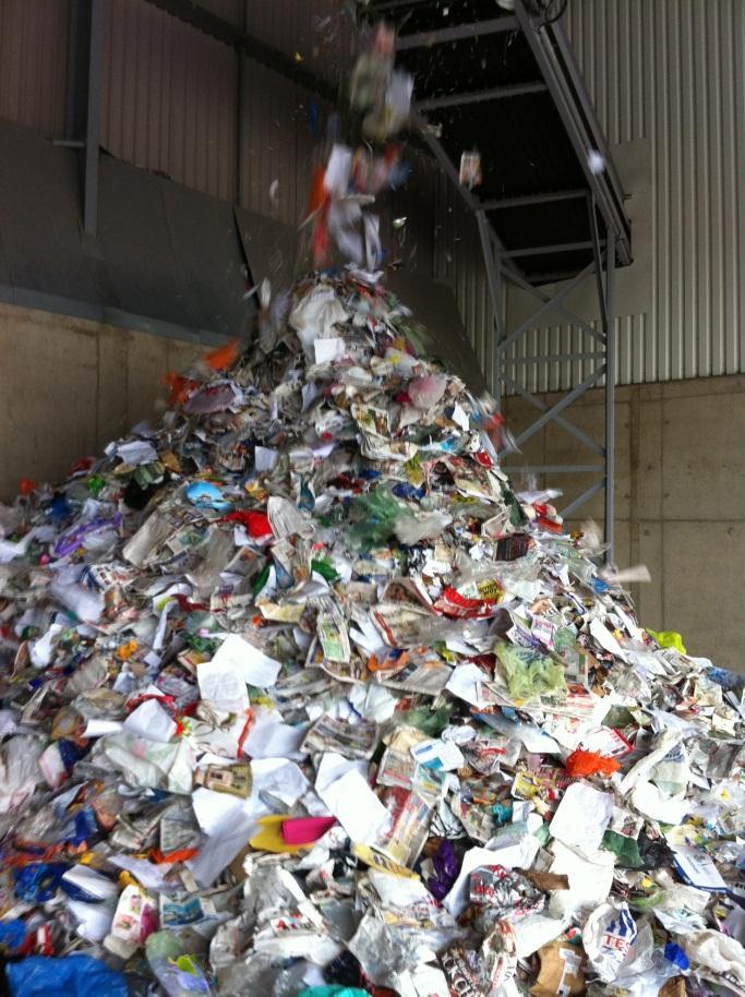 representative of the original material received at the Casepak MRF. Figure 5 shows the loading of co-mingled kerbside recyclable materials at the MRF.