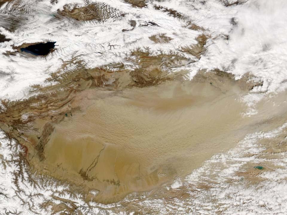 On March 26, 2004, MODIS/Aqua captured this true-color image of a dust storm blowing over the sands of the Taklimakan Desert.