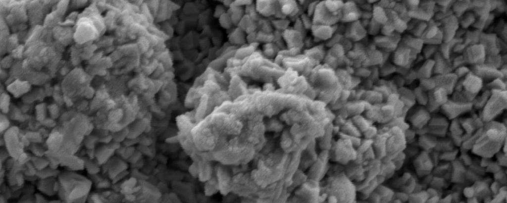 SEM image of bismuth oxide thin film on glass substrates shows granular morphology but the morphology on alumina showed triangular shaped grains.