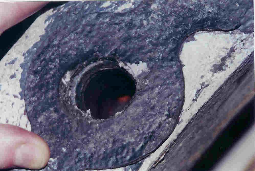 Gasket held in position over a hole that