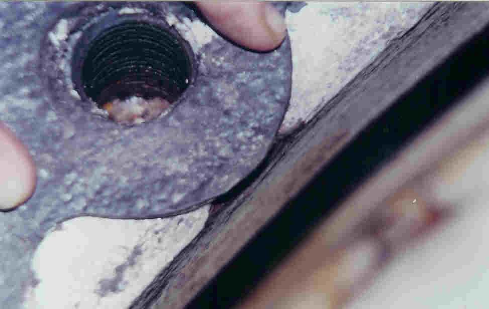 Gasket held in position over a hole