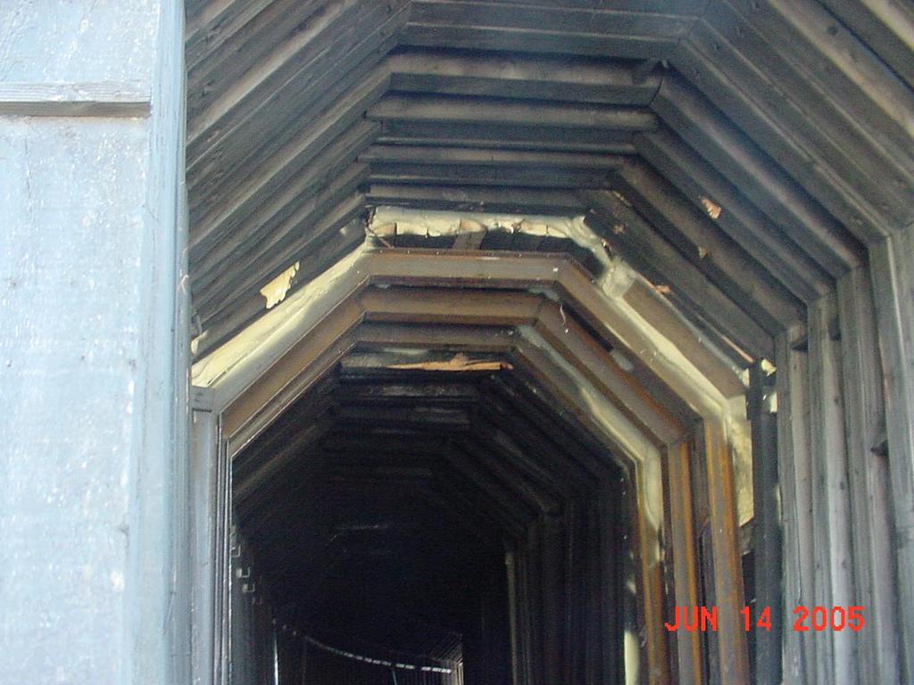 The north portal area of the Moody Tunnel collapsed in June 2005, and repairs were made with reinforcing vertical steel sets and polyurethane foam. Refer to the photograph below.