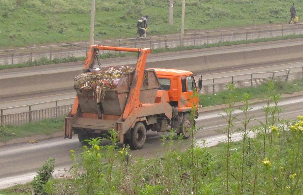 Figure 3. Container truck transporting a skip to the dump site. Source: Stratus Consulting. Transfer Stations The city is in the process of constructing two new transfer stations.