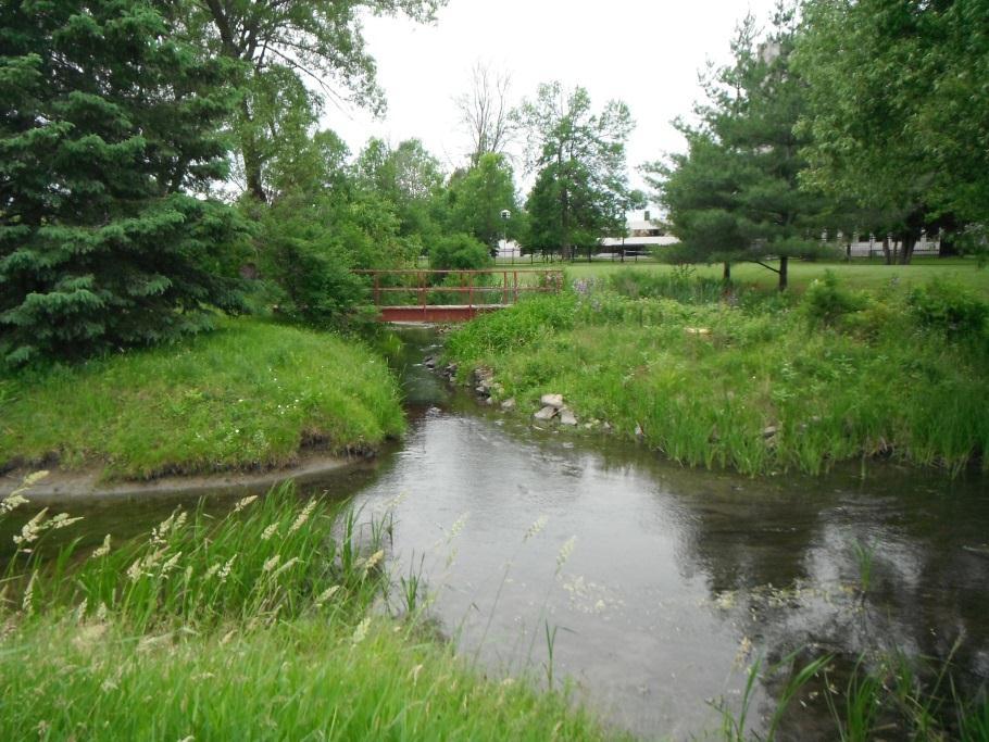 g. By restricting flow rates and causing upstream flooding, the 1200 mm diam. culvert impacts the Nordion campus land uses.