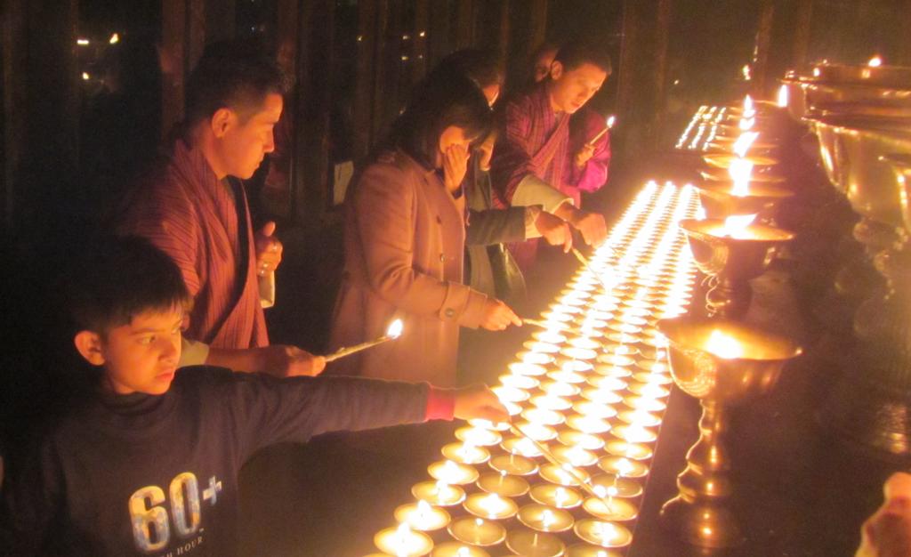 Campaign 8 Earth Hour Participants light butter lamps at the memorial chorten after the lights were put out during the earth hour.