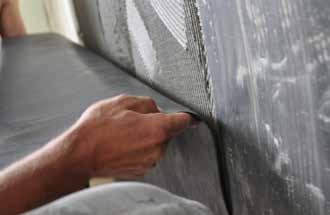 K-FONIK GK sheets (high density rubber 3mm thick) are applied to the existing masonry wall, made ready with a thin layer of tile adhesive using a serrated trowel.