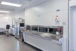 carousel connected to the cleanroom for product transfer and storage, as well as a high-speed oral solid packager and a liquid packaging machine.