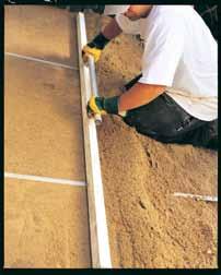 The easiest way to screed Sand is to use two guides (screed rails) and a screeding board (e.g. a flat piece of timber). Establish bedding tracks with the screeding board.