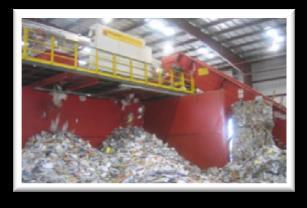 Process waste feedstock at high temperatures to produce an energy-rich synthesis gas and other products.